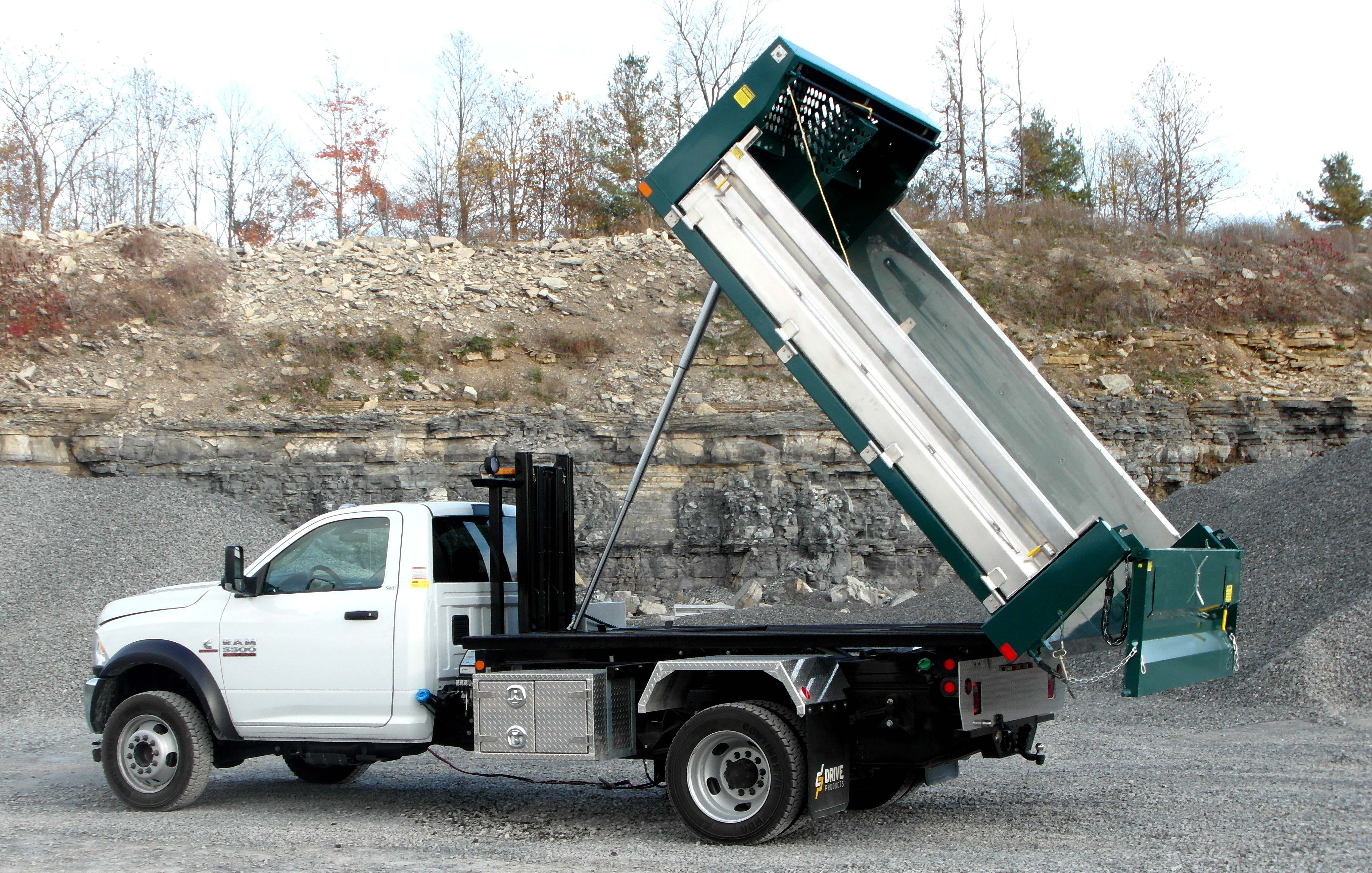Side view of Kargo King with a tilted dump truck