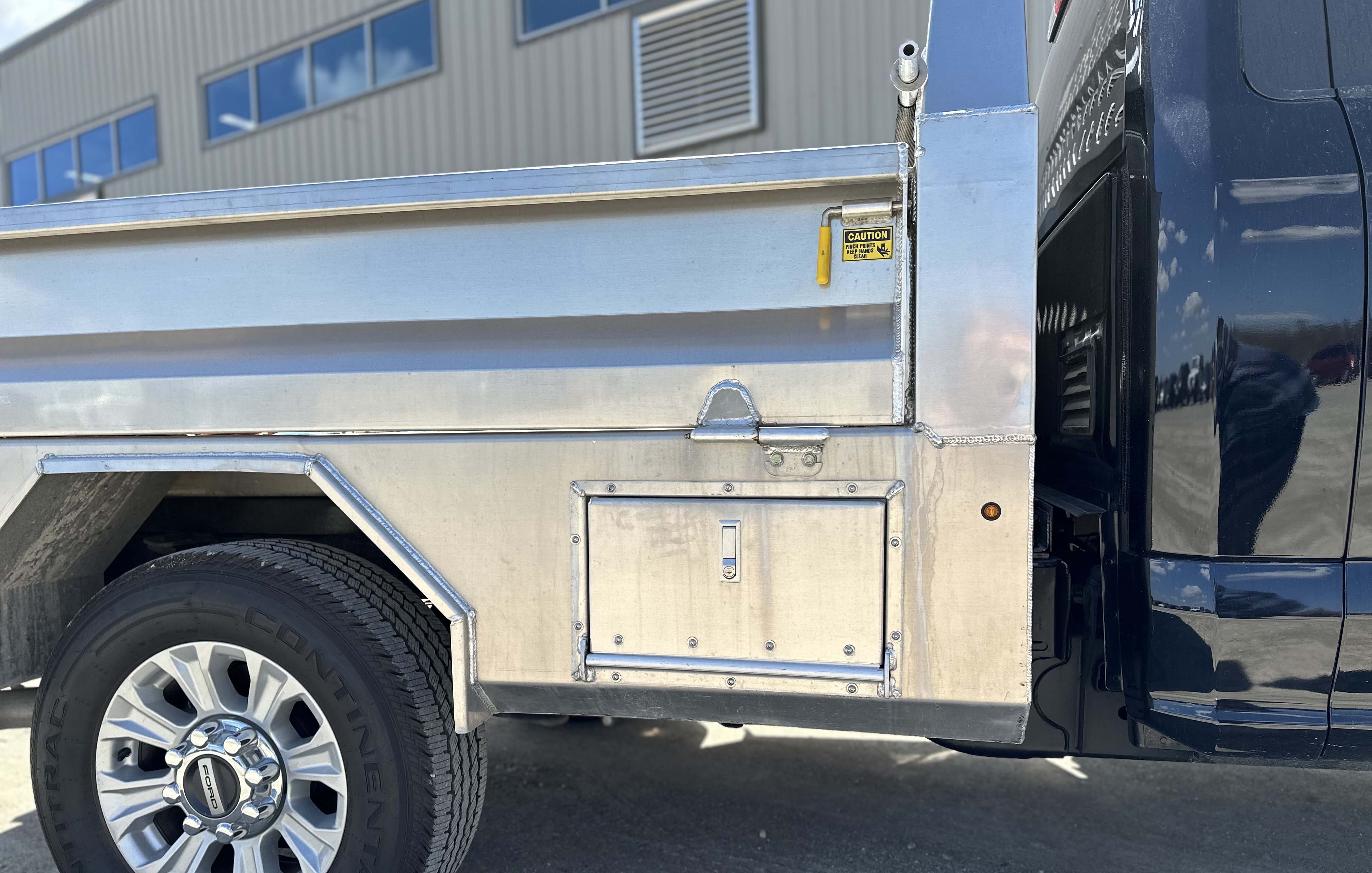 Curb side view of Voth Unibody Box Delete Truck - storage compartment