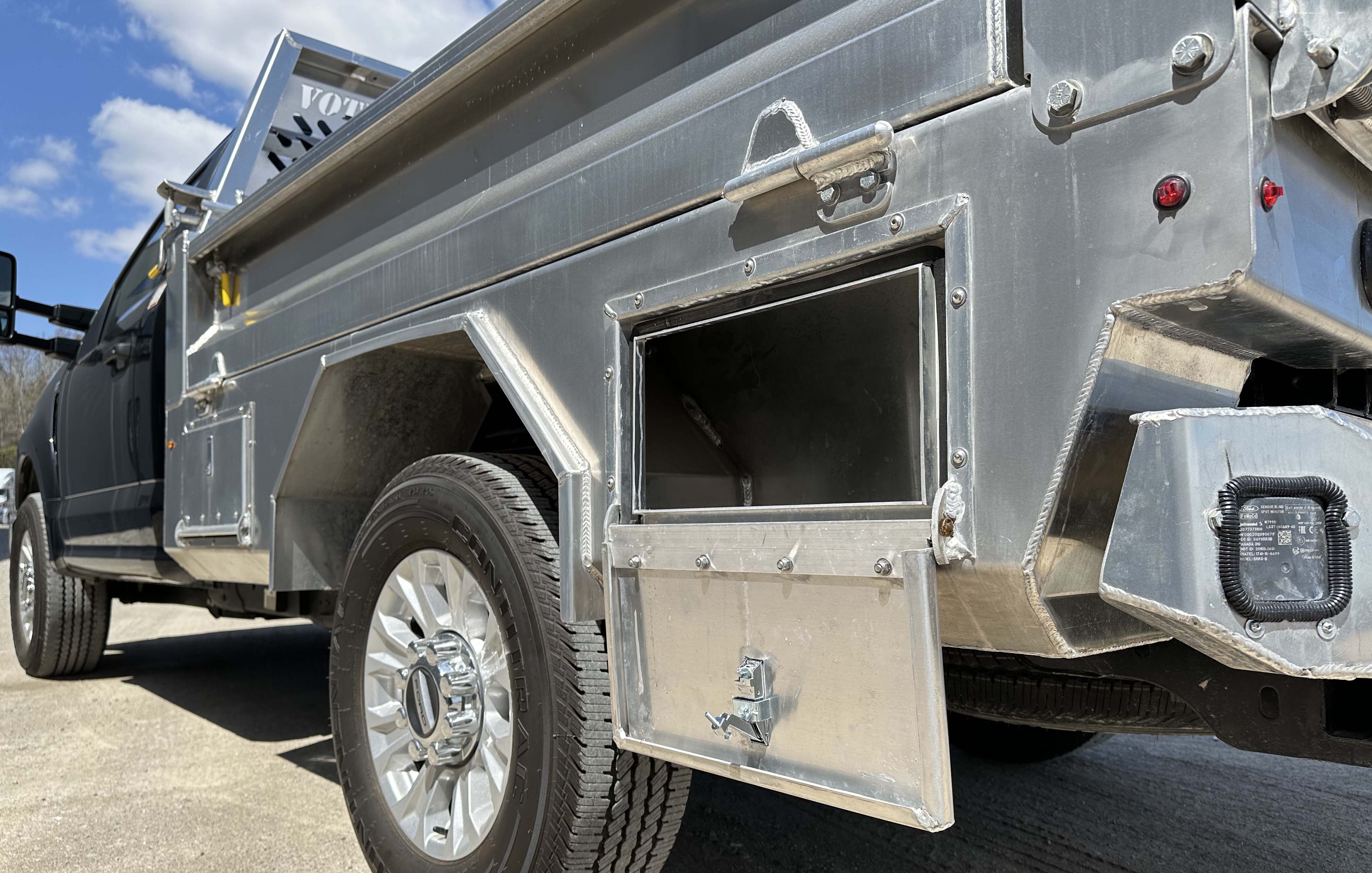 Driver side view of Voth Unibody Box Delete Truck - storage compartment