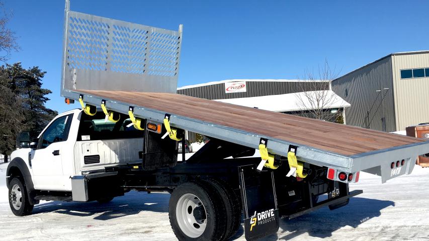 side view of galvanized steel dumping flat deck with wood floor